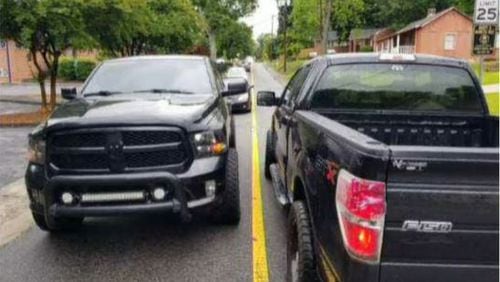 Two pickup trucks pass along a narrow stretch of Lawrence Street in Marietta. City officials say the photo shows how closely passing vehicles travel on the residential road. (Photo courtesy of City of Marietta)