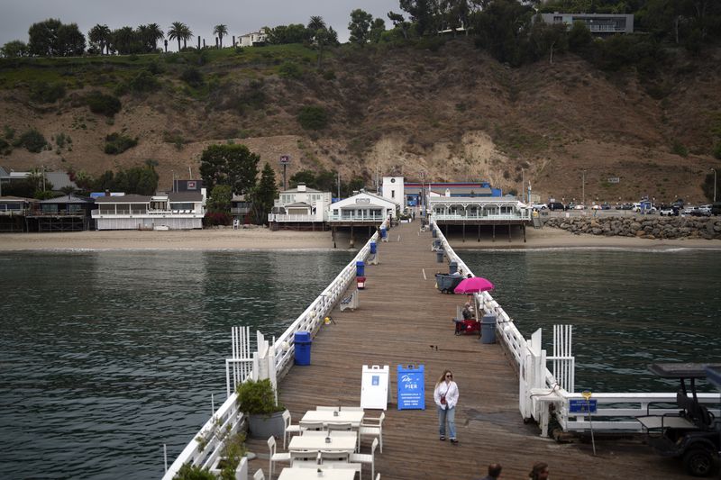 A visitor walks on the pier Thursday, Sept. 12, 2024, in Malibu, Calif., following a 4.7 magnitude earthquake in the area. (AP Photo/Eric Thayer)