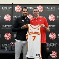Atlanta Hawks Nikola Djurišić (right) and General Manager Landry Fields hold up Djurišić's jersey during a press conference at Emory Sports Medicine Complex, Friday, June 28, 2024, in Brookhaven. Atlanta Hawks General Manager Landry Fields introduced 2024 NBA Draft selections Zaccharie Risacher (first overall pick) and Nikola Djurisic (43th overall pick) during a press conference.(Hyosub Shin / Hyosub.Shin@ajc.com)