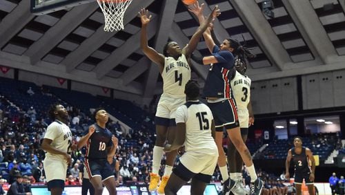 March 12, 2022 Macon - Berkmar's Malique Ewin (21) shoots over Norcross' Samarion Bond (4) during the 2022 GHSA State Basketball Class AAAAAAA Boys Championship game at the Macon Centreplex in Macon on Saturday, March 12, 2022. Norcross won 58-45 over Berkmar. (Hyosub Shin / Hyosub.Shin@ajc.com)