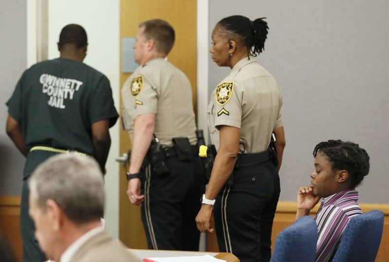 April 25, 2019 - Lawrenceville - Emani Moss’ father, Eman Moss, is escorted from court after he testified at his wife’s capital murder trial. Tiffany Moss (right) showed little emotion during his testimony. Eman Moss agreed to a plea deal that allowed him to avoid the penalty in exchange for testifying against Tiffany Moss.