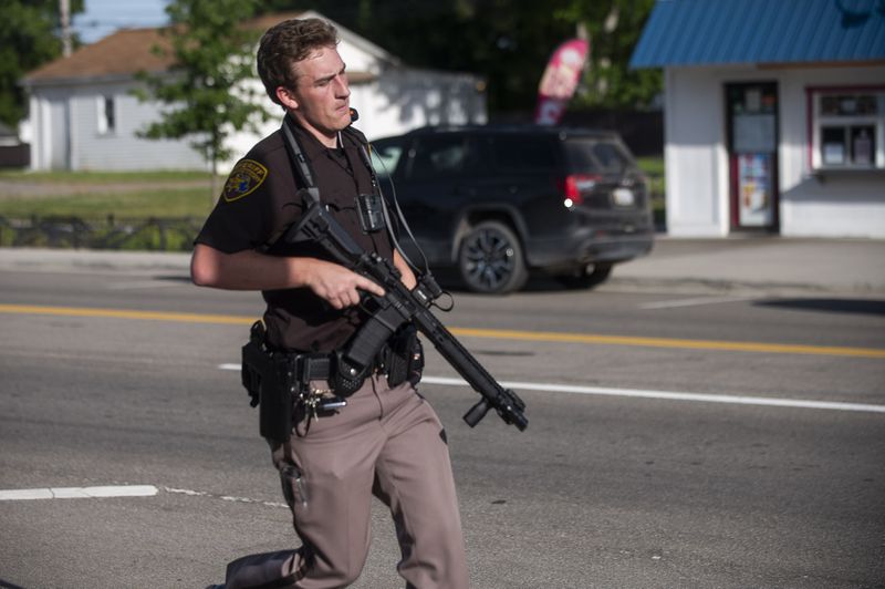 An officer with the Oakland County Sheriff's Department secures the scene of a shooting at the Brooklands Plaza Splash Pad, Saturday, June 15, 2024, in Rochester Hills, Mich. (Katy Kildee, The Detroit News/Detroit News via AP)