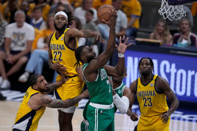 Boston Celtics guard Jaylen Brown (7) drives to the basket between Indiana Pacers forward Obi Toppin, left, forward Isaiah Jackson (22) and forward Aaron Nesmith (23) during the first half of Game 3 of the NBA Eastern Conference basketball finals, Saturday, May 25, 2024, in Indianapolis. (AP Photo/Darron Cummings)