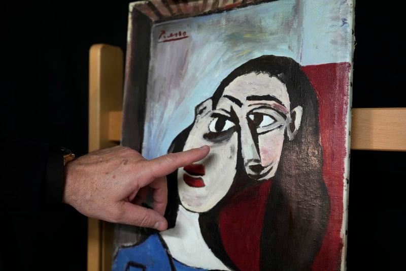 Luca Marcante, founder of the Arcadia Foundation, poses next to a painting in Milan, Italy, Thursday, Oct. 3, 2024. An Italian family hopes to prove definitively that a painting discarded from a villa on Capri more than 60 years ago is a Picasso. (AP Photo/Antonio Calanni)