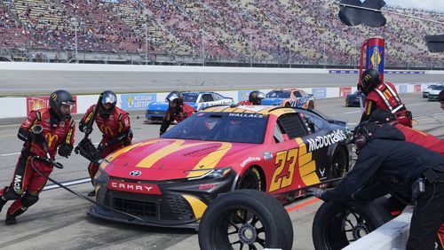 Bubba Wallace makes a pitstop during a NASCAR Cup Series auto race at Michigan International Speedway, Monday, Aug. 19, 2024, in Brooklyn, Mich. (AP Photo/Carlos Osorio)