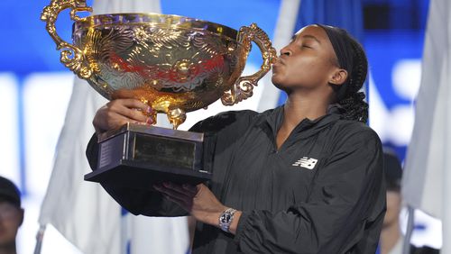 Coco Gauff of the United States kisses the trophy after defeating Karolina Muchova of Czech Republic in the women's singles final match at the China Open tennis tournament at the National Tennis Center in Beijing, Sunday, Oct. 6, 2024. (AP Photo/Achmad Ibrahim)