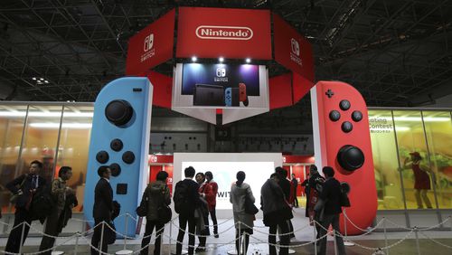 Media wait outside the venue for the presentation of the new Nintendo Switch in Tokyo, Friday, Jan. 13, 2017. Nintendo Co. said Friday that its Nintendo Switch video game console will sell for 29,980 yen (about $260) in Japan, starting March 3. (AP Photo/Koji Sasahara)