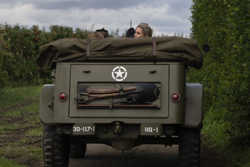 Dutch Queen Maxima looks back from a jeep during a ceremony marking the 80th anniversary of the liberation of the south of the Netherlands in Mesch, Thursday, Sept. 12, 2024. (AP Photo/Peter Dejong, Pool)