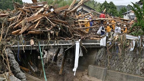 Rescuers search where houses were swept away along a river in Wajima, Japan, Sunday, Sept. 22, 2024, following heavy rain in central Japan's Noto peninsula area, where a devastating earthquake took place on Jan. 1. (Muneyuki Tomari/Kyodo News via AP)