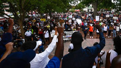 Protesters demonstrate on the square after  making their way from the Cobb NAACP offices to Marietta Square during a demonstration to commemorate Juneteenth on Friday June 19, 2020, in Marietta. JOHN AMIS FOR THE ATLANTA JOURNAL-CONSTITUTION