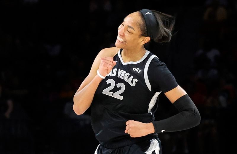 Las Vegas Aces center A'ja Wilson (22) celebrates after making a basket during the first half of an WNBA basketball game against the Connecticut Sun, Sunday, Sept. 15, 2024, in Las Vegas. (Steve Marcus/Las Vegas Sun via AP)