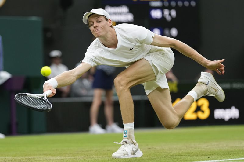 Jannik Sinner of Italy plays a forehand return to Daniil Medvedev of Russia during their quarterfinal match at the Wimbledon tennis championships in London, Tuesday, July 9, 2024. (AP Photo/Alberto Pezzali)
