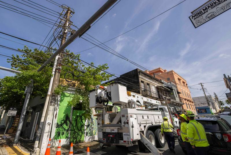 Electric workers carry out repairs in the community of Puerta de Tierra after the passage of Tropical Storm Ernesto in San Juan, Puerto Rico, Thursday, Aug. 15, 2024. (AP Photo/Alejandro Granadillo)