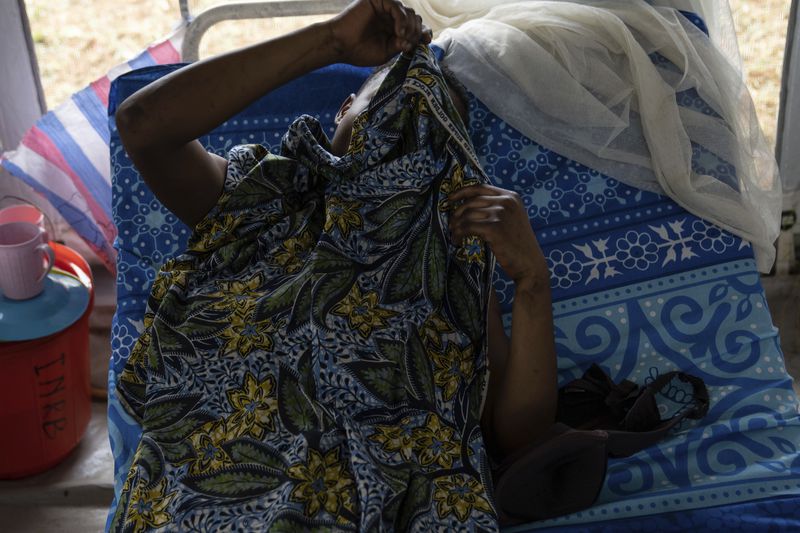 A sex worker suffering from mpox, lies down Wednesday, Sept. 4, 2024 in the general hospital in Kamituga, eastern Congo. (AP Photo/Moses Sawasawa