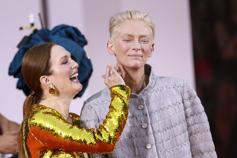 Julianne Moore, left, and Tilda Swinton pose for photographers upon arrival for the premiere of the film 'The Room Next Door' during the 81st edition of the Venice Film Festival in Venice, Italy, on Monday, Sept. 2, 2024. (Photo by Vianney Le Caer/Invision/AP)