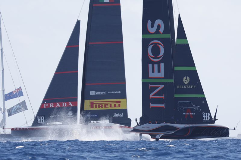 INEOS Britannia, right, and Luna Rosa Prada Pirelli sailing teams compete during the Louis Vuitton Cup Final Day 7 at the Barcelona's coast, Spain, Friday, Oct. 4, 2024. (AP Photo/Joan Monfort)