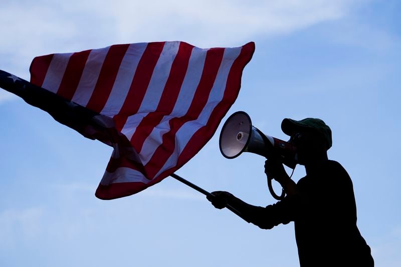 A counter protester yells at demonstrators during a rally near the Democratic National Convention Thursday, Aug. 22, 2024, in Chicago. (AP Photo/Julio Cortez)