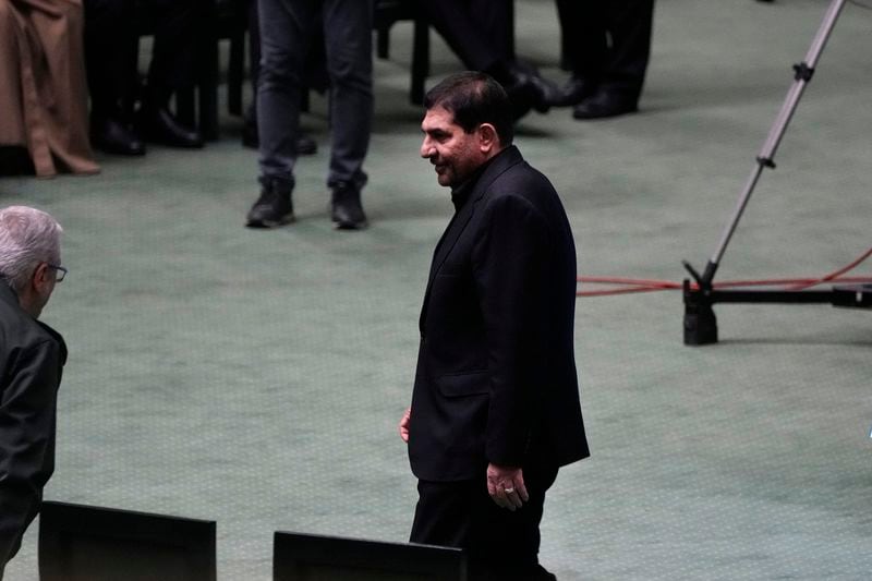 Iran's acting President Mohammad Mokhber walks through the parliament chamber during the opening ceremony of a new parliament term, in Tehran, Iran, Monday, May 27, 2024. Mokhber addressed the country's new parliament Monday in his first public speech since last week's helicopter crash that killed his predecessor and seven others. (AP Photo/Vahid Salemi)