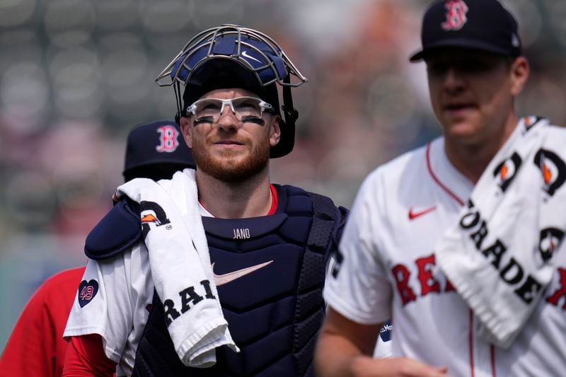 Boston Red Sox catcher Danny Jansen heads to the dugout to prior baseball game, which was delayed due to rain in June, against the Toronto Blue Jays at Fenway Park, Monday, Aug. 26, 2024, in Boston. Jansen, who was traded by the Blue Jays to the Red Sox on July 27th, is in the line-up against his former team when the delayed game continues Monday afternoon. Jansen will become the first major league player to appear in the same game for both teams. (AP Photo/Charles Krupa)