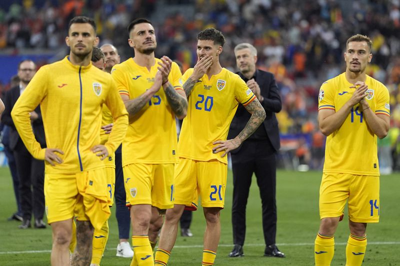 Romania players react after a round of sixteen match between Romania and the Netherlands at the Euro 2024 soccer tournament in Munich, Germany, Tuesday, July 2, 2024. (AP Photo/Ariel Schalit)