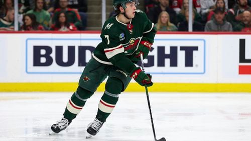 FILE - Minnesota Wild defenseman Brock Faber skates with the puck during the second period of an NHL hockey game against the Ottawa Senators Tuesday, April 2, 2024, in St. Paul, Minn. Minnesota Wild general manager Bill Guerin saw enough potential in Brock Faber's rookie season to sign the defenseman to an eight-year, $68 million contract extension on Monday, July 29, 2024. (AP Photo/Matt Krohn, File)