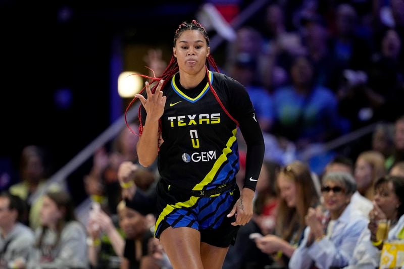 Dallas Wings forward Satou Sabally (0) celebrates after sinking a 3-point basket in the first half of a WNBA basketball game against the Indiana Fever, Sunday, Sept. 1, 2024, in Arlington, Texas. (AP Photo/Tony Gutierrez)