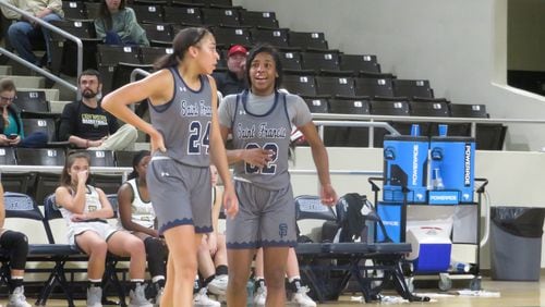 St. Francis Lady Knights Mia Moore (22) and Savannah Samuel (24) talk during a break in their Class A Private semifinal game against the Wesleyan Lady Wolves on Friday, Feb. 28, 2020 at Georgia College and State University'sCentennial Center in Milledgeville. (Adam Krohn for the AJC)