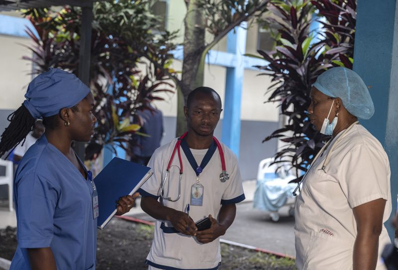 Medical staff talk to each other at the general hospital in Goma, Democratic Republic Of Congo, Wednesday, Aug. 14, 2024 after the World Health Organization declared the mpox outbreaks in Congo and elsewhere in Africa a global emergency. (AP Photo/Moses Sawasawa)