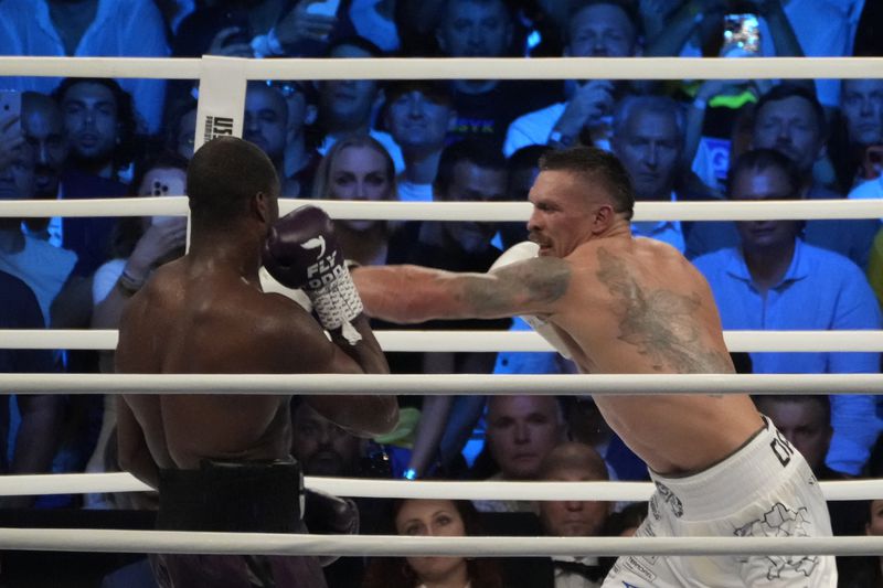 FILE - Ukraine's Oleksandr Usyk, right, lands a blow on Britain's Daniel Dubois during their world heavyweight title fight at Tarczynski Arena in Wroclaw, Poland, Sunday, Aug. 27, 2023. (AP Photo/Czarek Sokolowski, file)