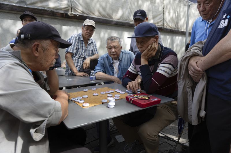 Men play Xiangqi, or Chinese chess, in a public park near a remembrance ceremony for Vincent Chin in Chinatown, Sunday, June 23, 2024, in Boston. Over the weekend, vigils were held across the country to honor the memory of Chin, who was killed by two white men in 1982 in Detroit. (AP Photo/Michael Dwyer)