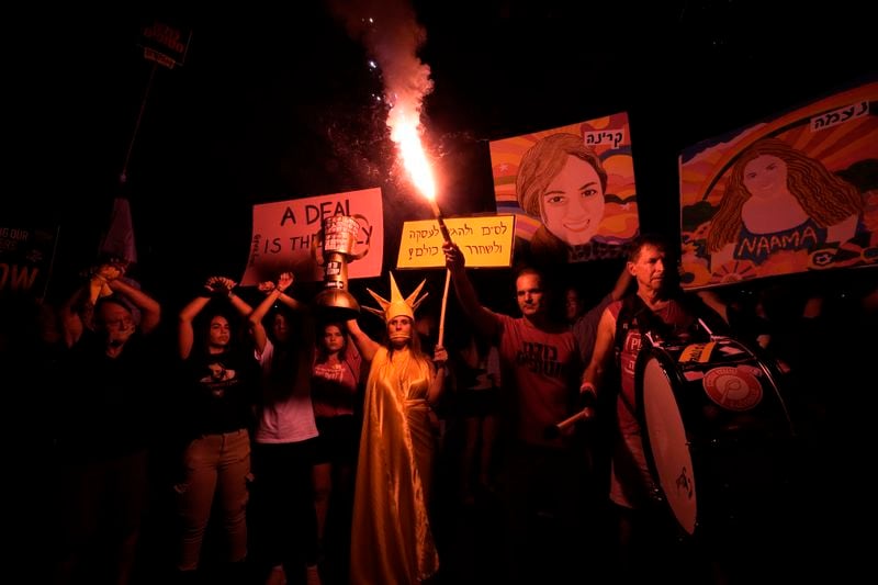 Relatives of hostages held by Hamas militants in the Gaza Strip and their supporters call for their immediate release and to protest against Israeli Prime Minister Benjamin Netanyahu's government in Tel Aviv, Israel, Saturday, Aug. 17, 2024. (AP Photo/Tsafrir Abayov)