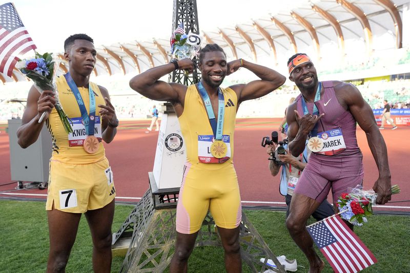 Noah Lyles celebrates after winning the men's 200-meter final with Kenny Bednarek and Erriyon Knighton during the U.S. Track and Field Olympic Team Trials Saturday, June 29, 2024, in Eugene, Ore. (AP Photo/George Walker IV)