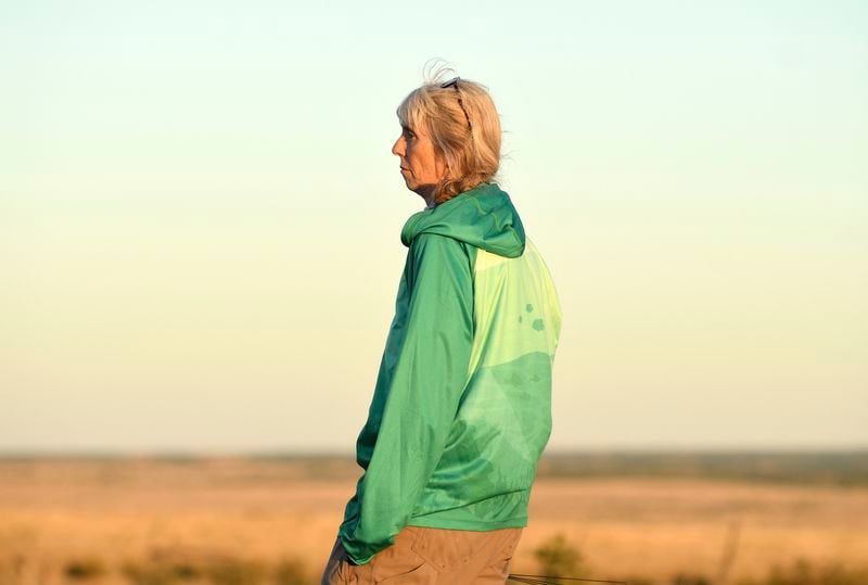 Dr. Cara Shillington, a biology professor at Eastern Michigan University, surveys the plains during tarantula mating season near La Junta, Colo., on Saturday, Sept. 28, 2024. (AP Photo/Thomas Peipert)