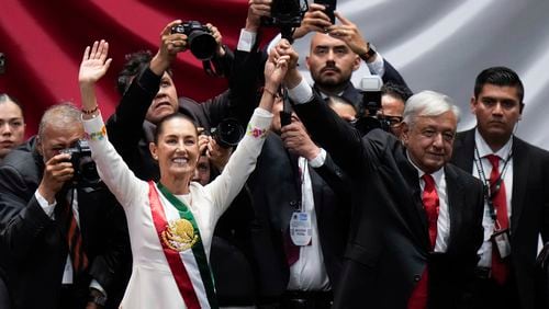 President Claudia Sheinbaum and outgoing President Andres Manuel López Obrador wave on her inauguration day at Congress in Mexico City, Tuesday, Oct. 1, 2024. (AP Photo/Eduardo Verdugo)