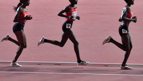 FILE - Hellen Obiri, Rosemary Monica Wanjiru and Agnes Jebet Tirop, from left to right, all of Kenya, compete in the women's 10,000 meter race during the World Athletics Championships in Doha, Qatar, Saturday, Sept. 28, 2019. (AP Photo/Martin Meissner, File)