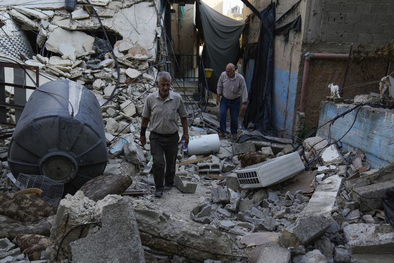 A Palestinian man inspects the damage to a building after Israeli forces raided the West Bank city of Jenin, Friday, Sept. 6, 2024. (AP Photo/Nasser Nasser)