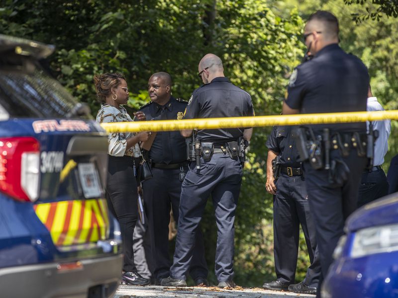 08/12/2021 — Atlanta, Georgia — Atlanta Police Department Deputy Chief Charles Hampton, Jr., second from left, joins APD members as they investigate a homicide scene at Lakewood Avenue SE and Terrace Way SE in Atlanta’s Lakewood Heights community, Friday, August 13, 2021. The body of Mariam Abdulrab was found in the area. (Alyssa Pointer/Atlanta Journal-Constitution)