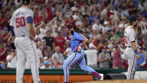 Philadelphia Phillies' Brandon Marsh, center, rounds the bases after hitting a three-run home run against Atlanta Braves pitcher Charlie Morton during the sixth inning of a baseball game, Thursday, Aug. 29, 2024, in Philadelphia. (AP Photo/Matt Slocum)