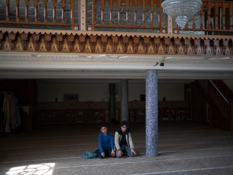 Students pray during recess in the mosque at Ibn Khaldoun, a private Muslim school, in Marseille, southern France, Tuesday, April 16, 2024. (AP Photo/Daniel Cole)