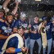 The New York Mets celebrate in the locker room after clinching a wild-card playoff berth after the second baseball game of a doubleheader against the Atlanta Braves, Monday, Sept. 30, 2024, in Atlanta. (AP Photo/Jason Allen)