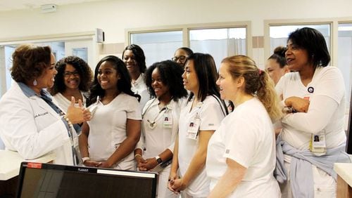 Dr. Jacqueline Herd, chief nursing officer at Grady Memorial Hospital, holds an informal briefing with nurses in the hospital’s intensive care unit.