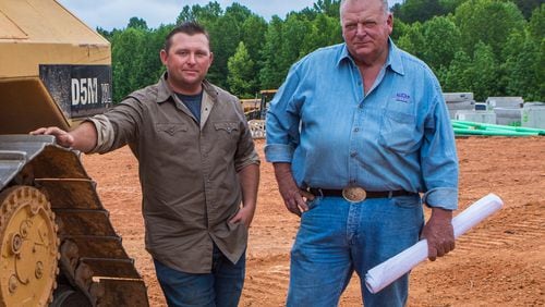 Stoney Birt, right, with son Stone Birt on the construction site for a new subdivision in Sugar Hill, contends that his father, Billy Sunday Birt, was a good father despite also being a serial murderer. Jenni Girtman for The Atlanta Journal-Constitution