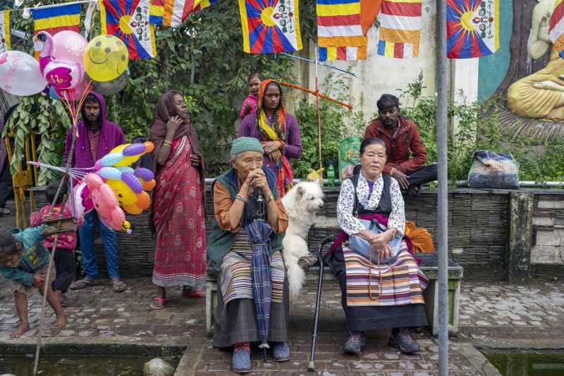 Exiled Tibetans wait to welcome their spiritual leader the Dalai Lama before he arrived in Dharamshala, India, Wednesday, Aug. 28, 2024. (AP Photo/Ashwini Bhatia)