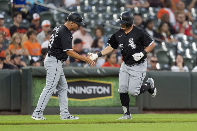 Chicago White Sox's Andrew Vaughn (25) celebrates with third base coach Justin Jirschele (28) after hitting a home run during the fourth inning of a baseball game against the Baltimore Orioles, Wednesday, Sept. 4, 2024, in Baltimore. (AP Photo/Stephanie Scarbrough)