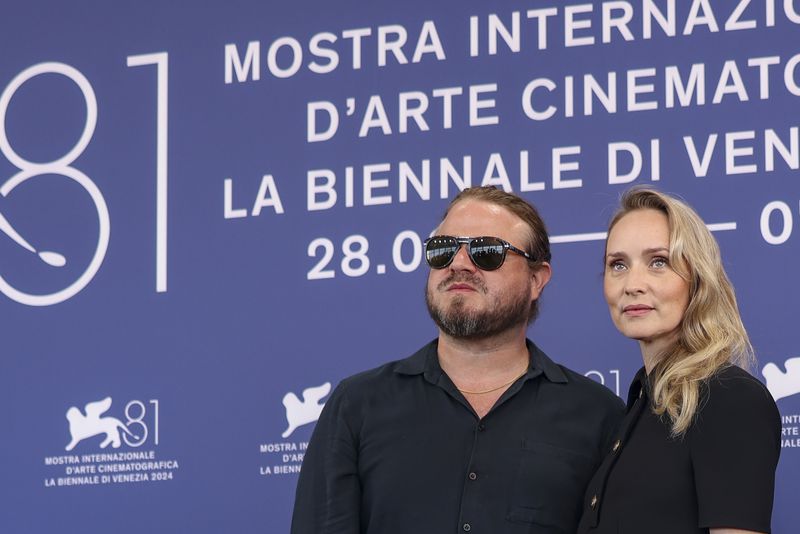 Director Brady Corbet, left, and writer Mona Fastvold pose for photographers at the photo call for the film 'The Brutalist' during the 81st edition of the Venice Film Festival in Venice, Italy, on Sunday, Sept. 1, 2024. (Photo by Vianney Le Caer/Invision/AP)