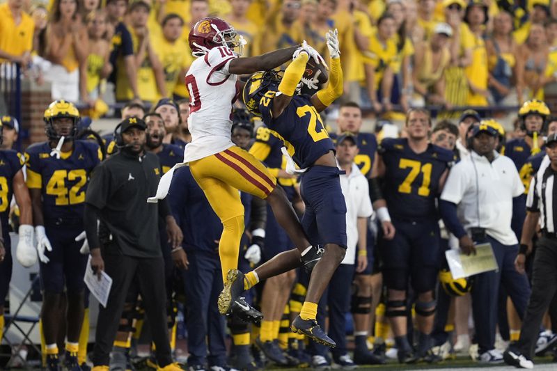 Michigan defensive back Jyaire Hill (20) breaks up a pass intended for Southern California wide receiver Kyron Hudson (10) in the second half of an NCAA college football game in Ann Arbor, Mich., Saturday, Sept. 21, 2024. (AP Photo/Paul Sancya)