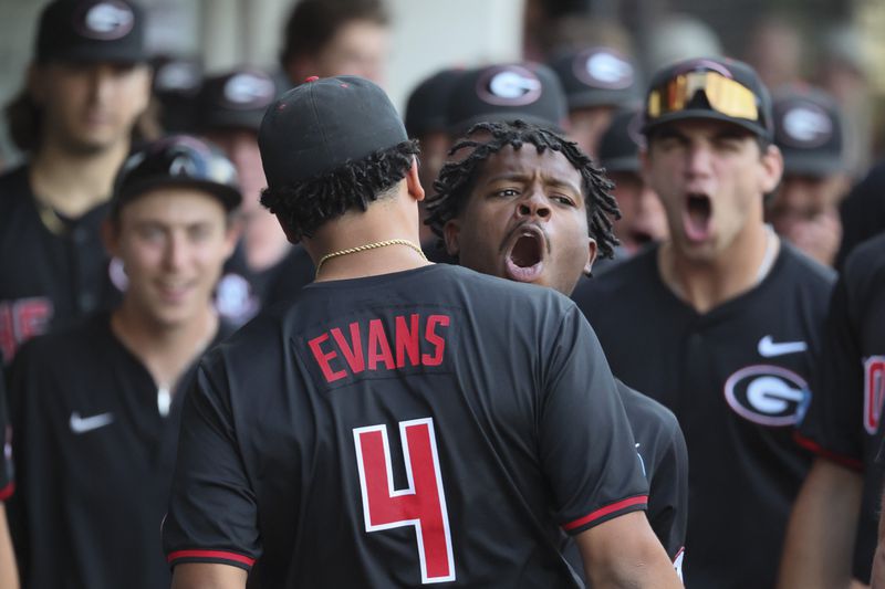 Georgia designated hitter Tre Phelps, facing, celebrates his two-run home run with Georgia’s Jarvis Evans (4) during the second inning against N.C. State in Game 3 of the NCAA Super Regional at Foley Field, Monday, June 10, 2024, in Athens, Ga. (Jason Getz / AJC)
