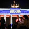 The Brandenburg Gate is illuminated with the flag of Israel in Berlin, Germany, Monday, Oct. 7, 2024, to mark the anniversary of the Hamas attack on Israel on Oct. 7, 2023. (Kay Nietfeld/dpa via AP)