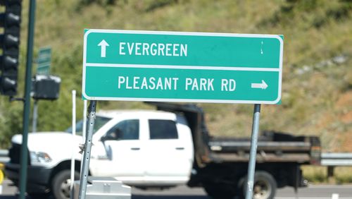 A sign off Highway 285 points motorists to Pleasant Park Road where a teenager, who was scouting for a location for lakeside homecoming photos, was shot in the face earlier this week by a town councilman, Friday, Sept. 13, 2024, near Conifer, Colo. (AP Photo/David Zalubowski)