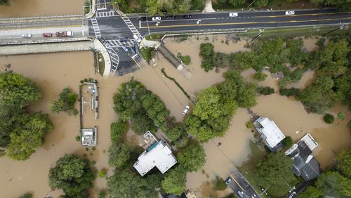 Peachtree Creek spills over its banks in Atlanta on Friday, Sept. 27, 2024 following a night of heavy rain from Hurricane Helene. Northside Drive NW is seen at the top of the photo. Ben Gray for the Atlanta Journal-Constitution